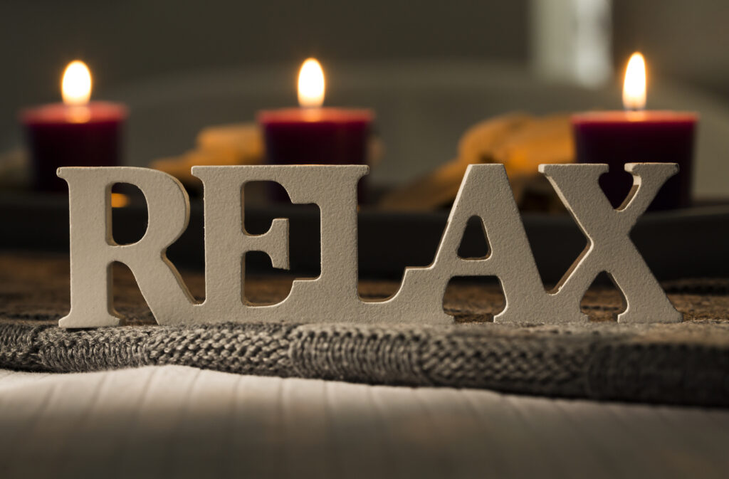 Spa Candles Behind Relax Sign