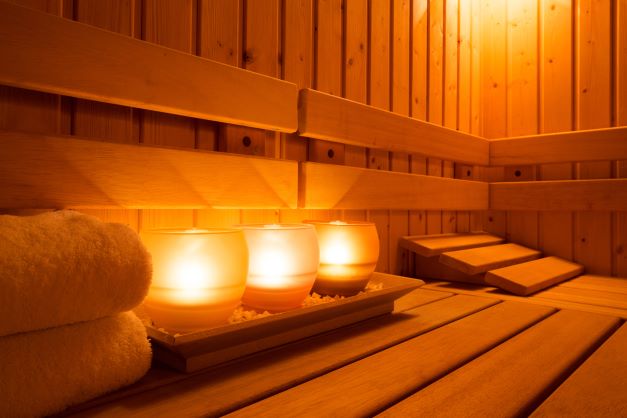 Sauna with towels and candles inside